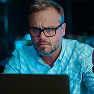 A man with a puzzled look on his face wondering if he's entered a malicious website or fallen victim to identity theft.